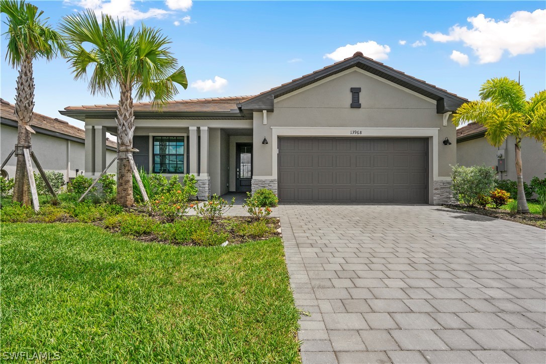 a front view of a house with a yard and garage