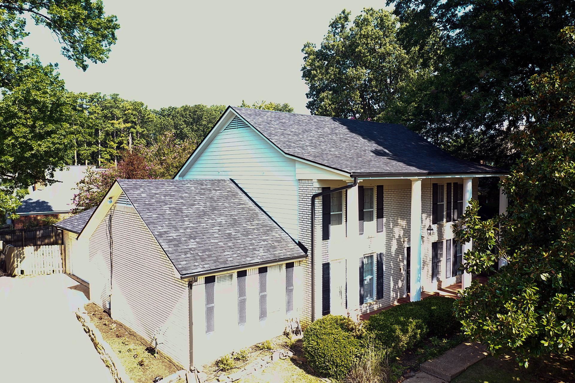 a aerial view of a house next to a yard