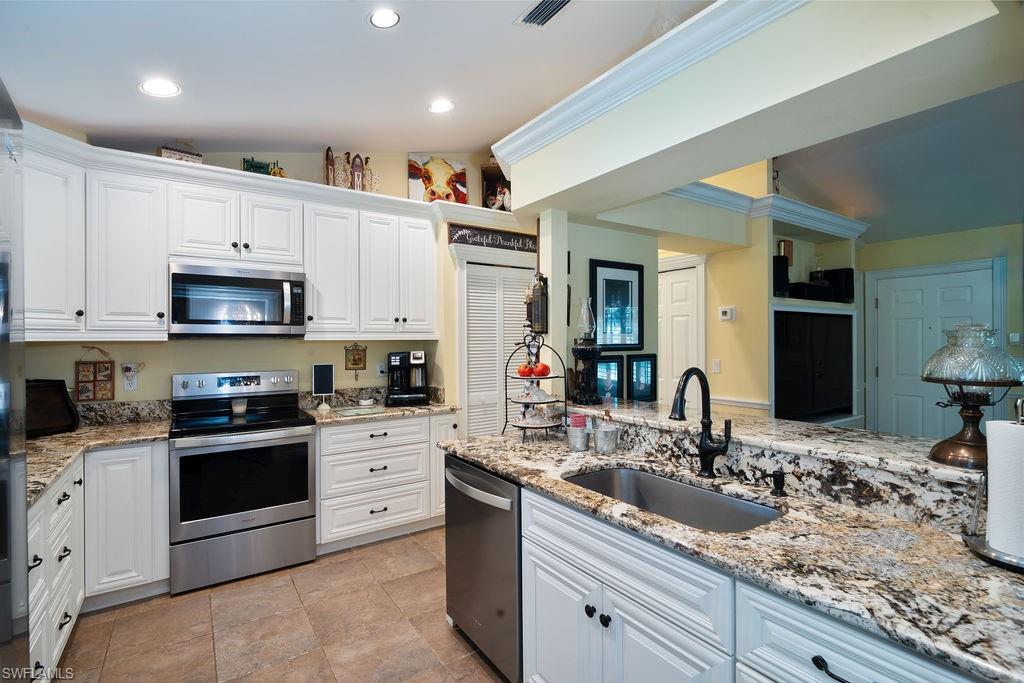 a kitchen with a sink stove and microwave