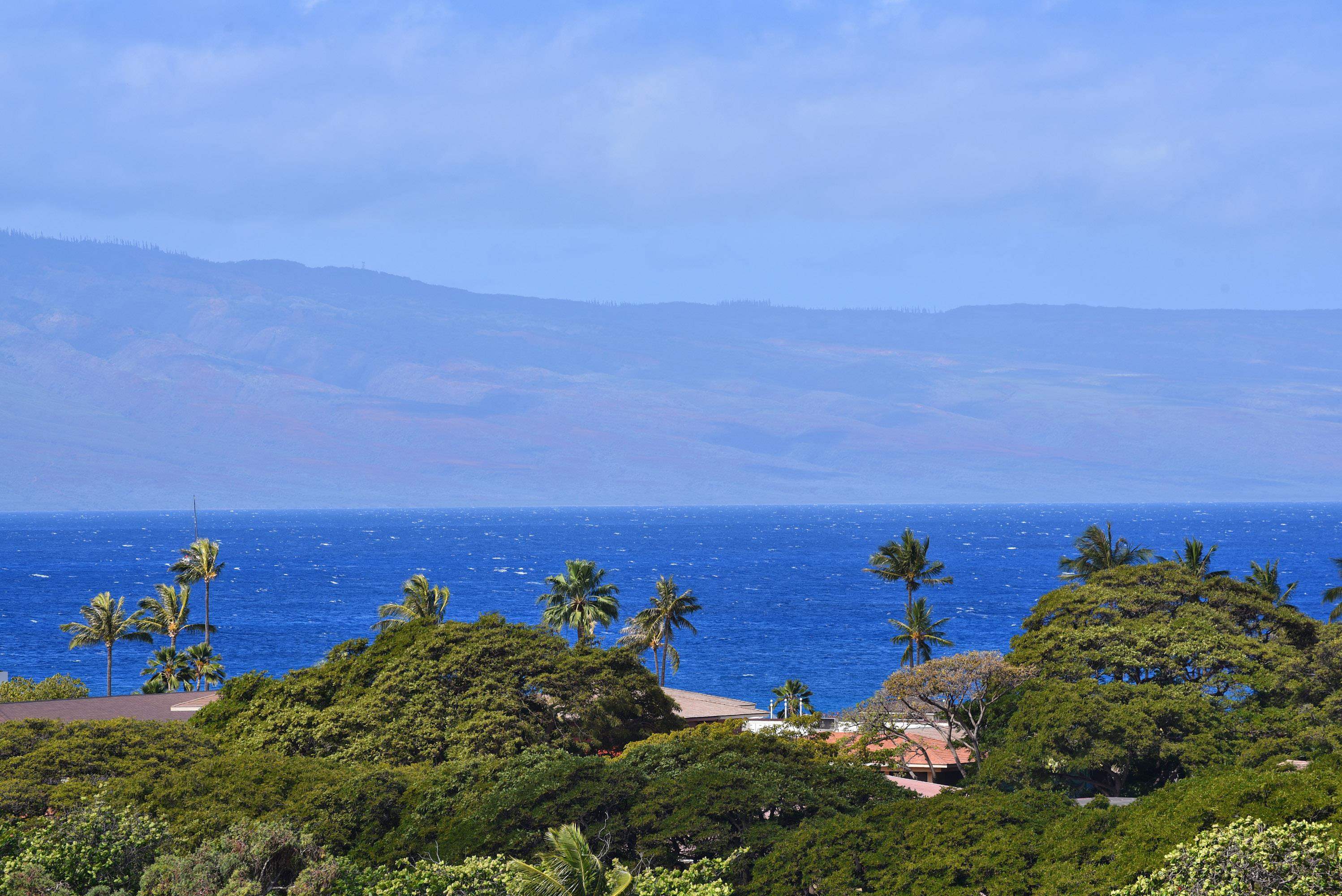 a view of a ocean with a building in the background