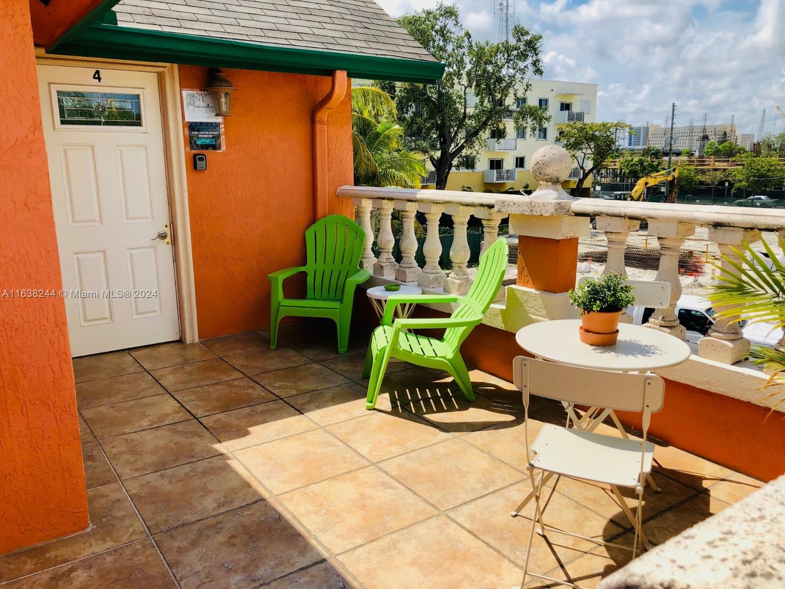 a view of a patio with table and chairs with wooden floor and fence