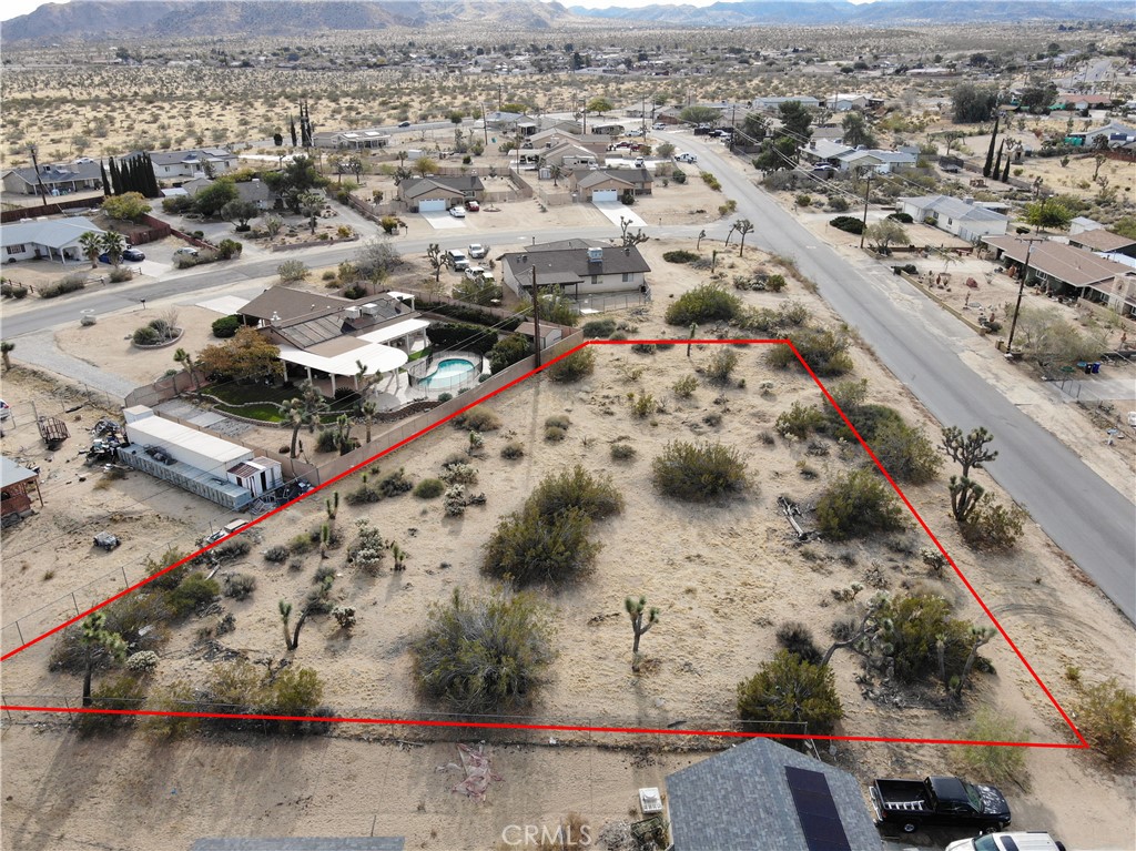 an aerial view of a residential houses with outdoor space