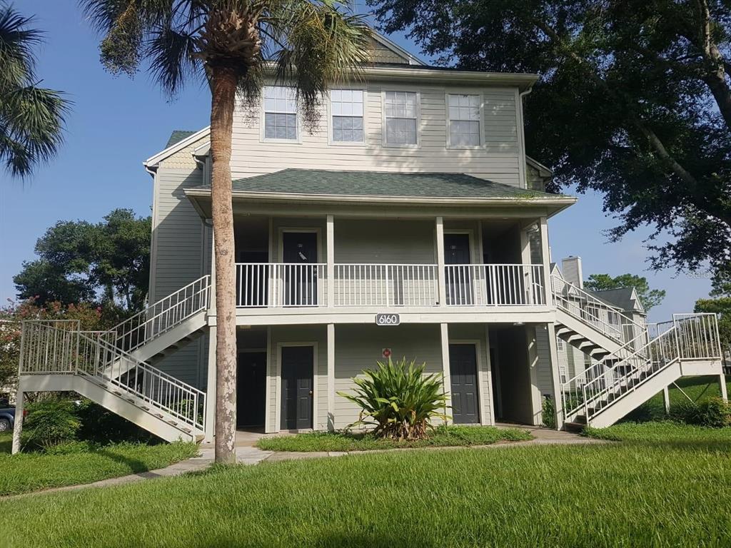 a view of house with a yard