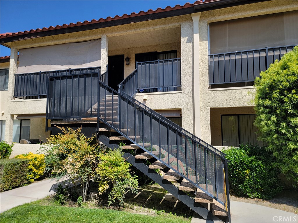 a view of a house with wooden fence