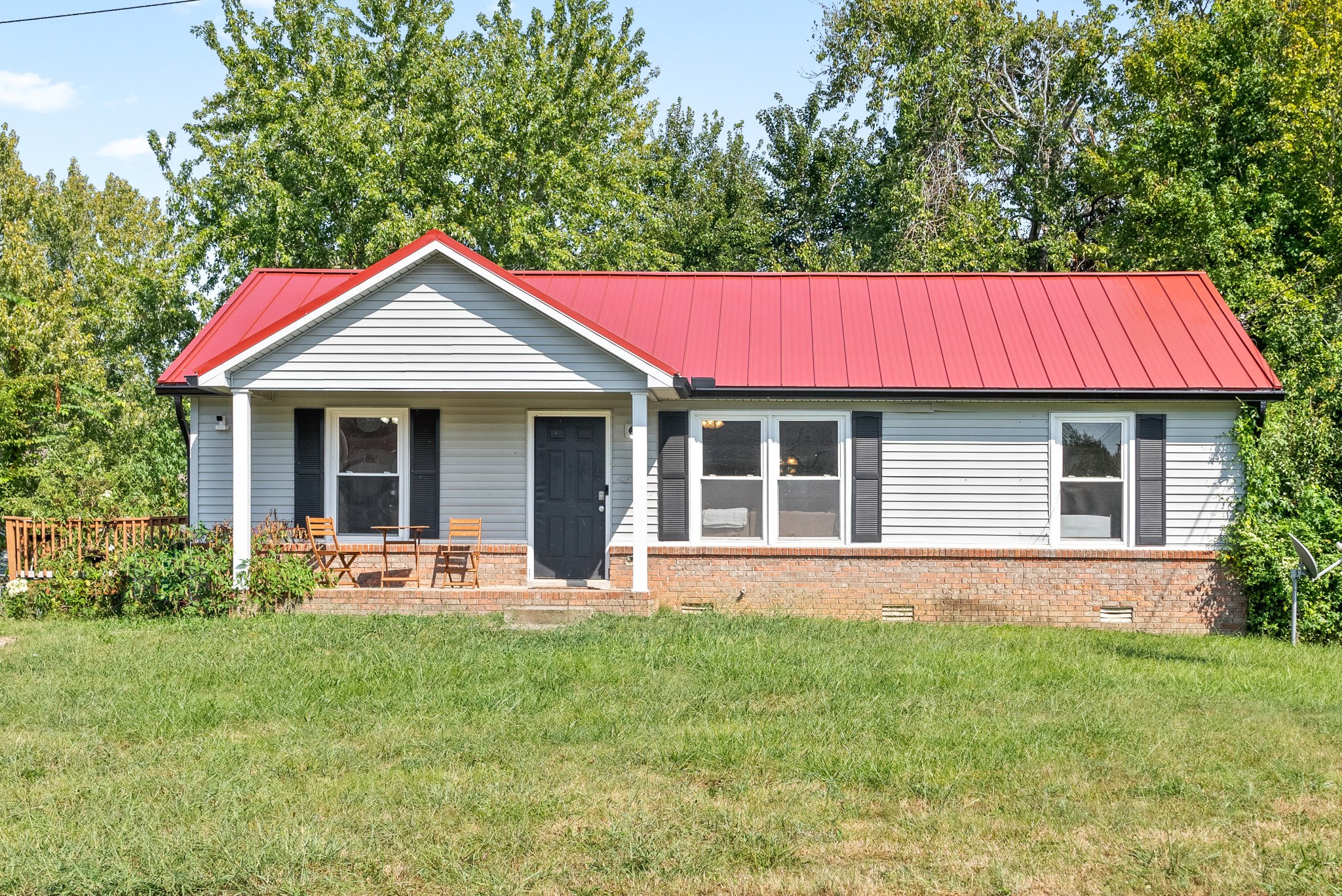 a front view of a house with a yard and porch