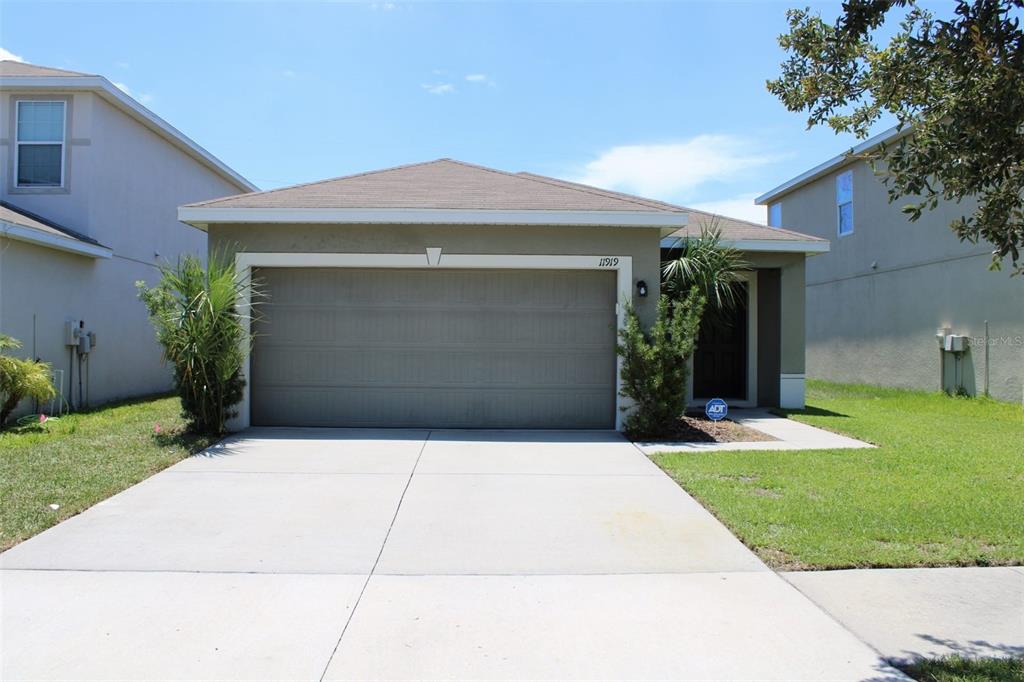 a front view of a house with a yard and garage