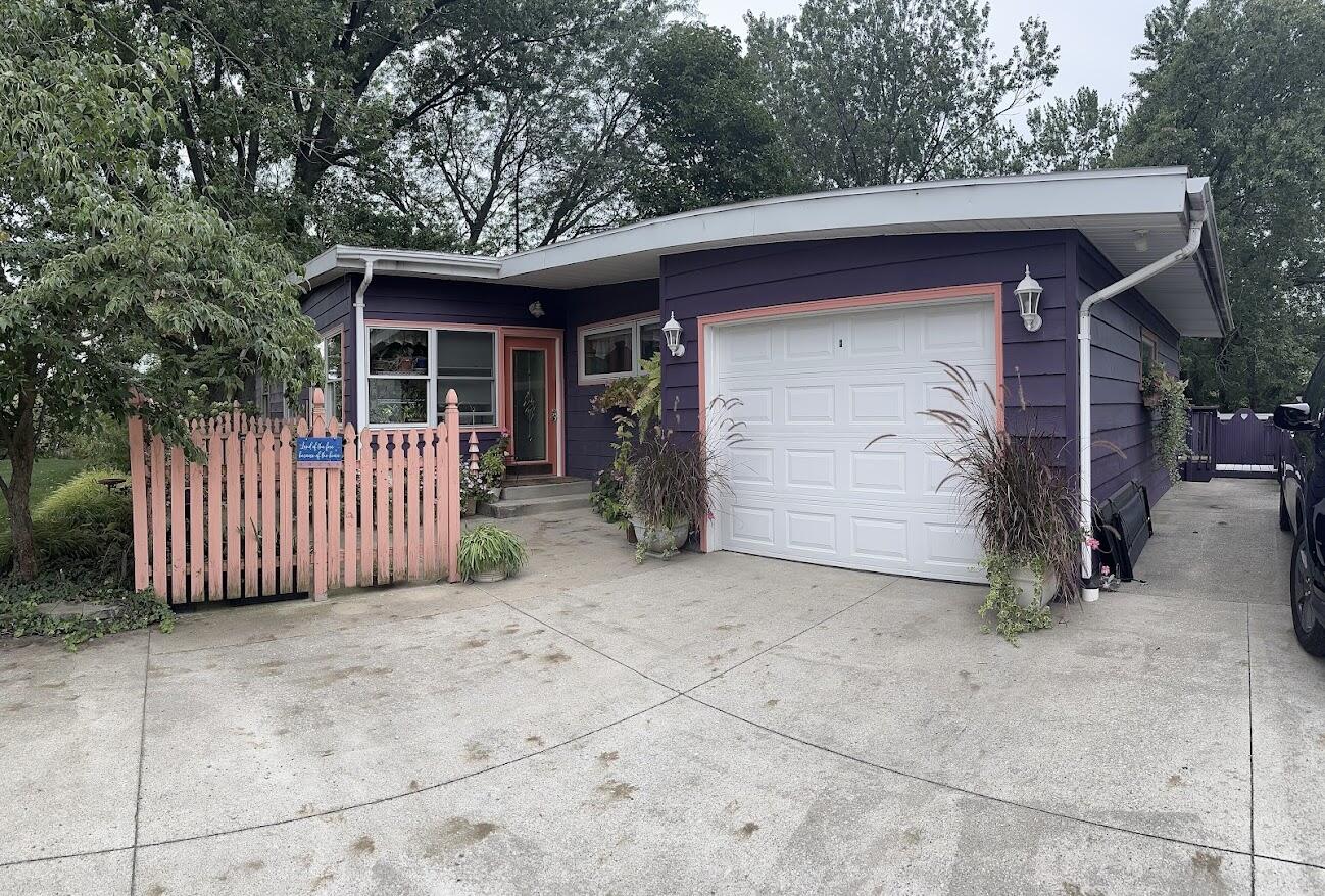 a view of a small house with a garage