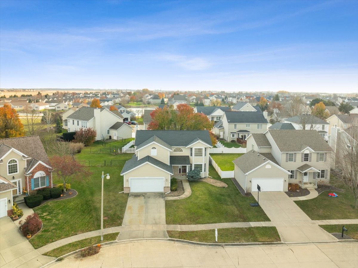 an aerial view of a house with a yard basket ball court and outdoor seating