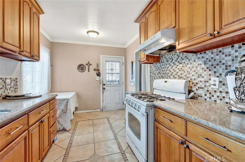 a kitchen with stainless steel appliances granite countertop a stove and a cabinets