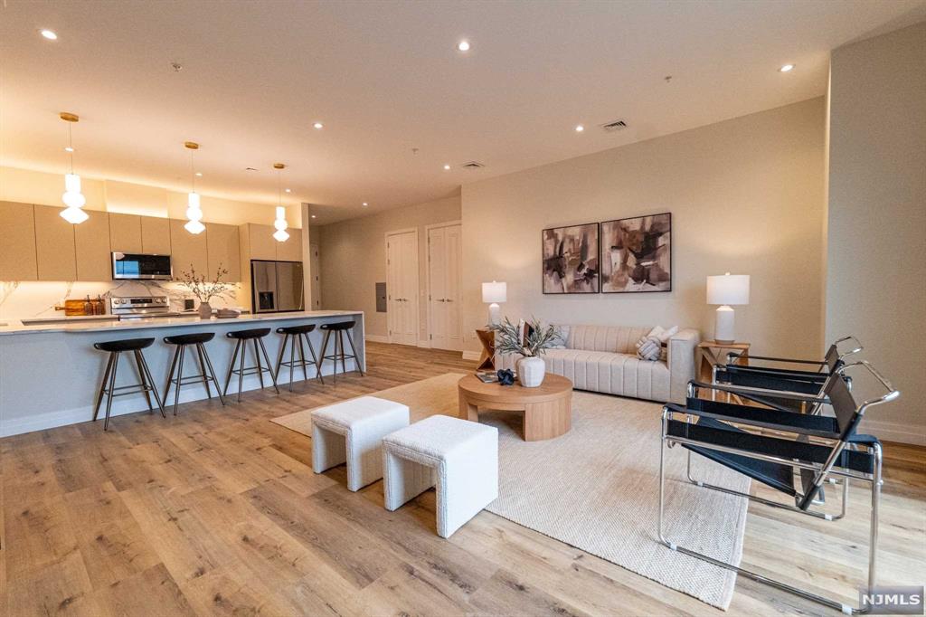 a living room with lots of furniture and a wooden floor