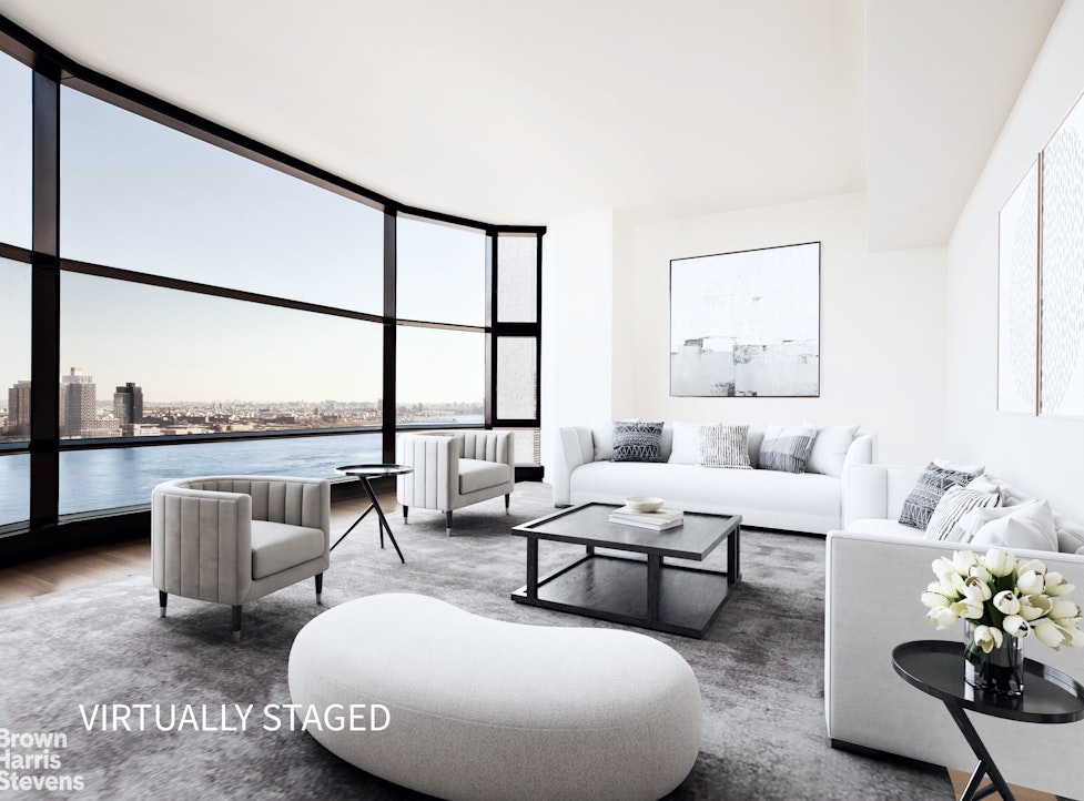 a living room with furniture and a floor to ceiling window