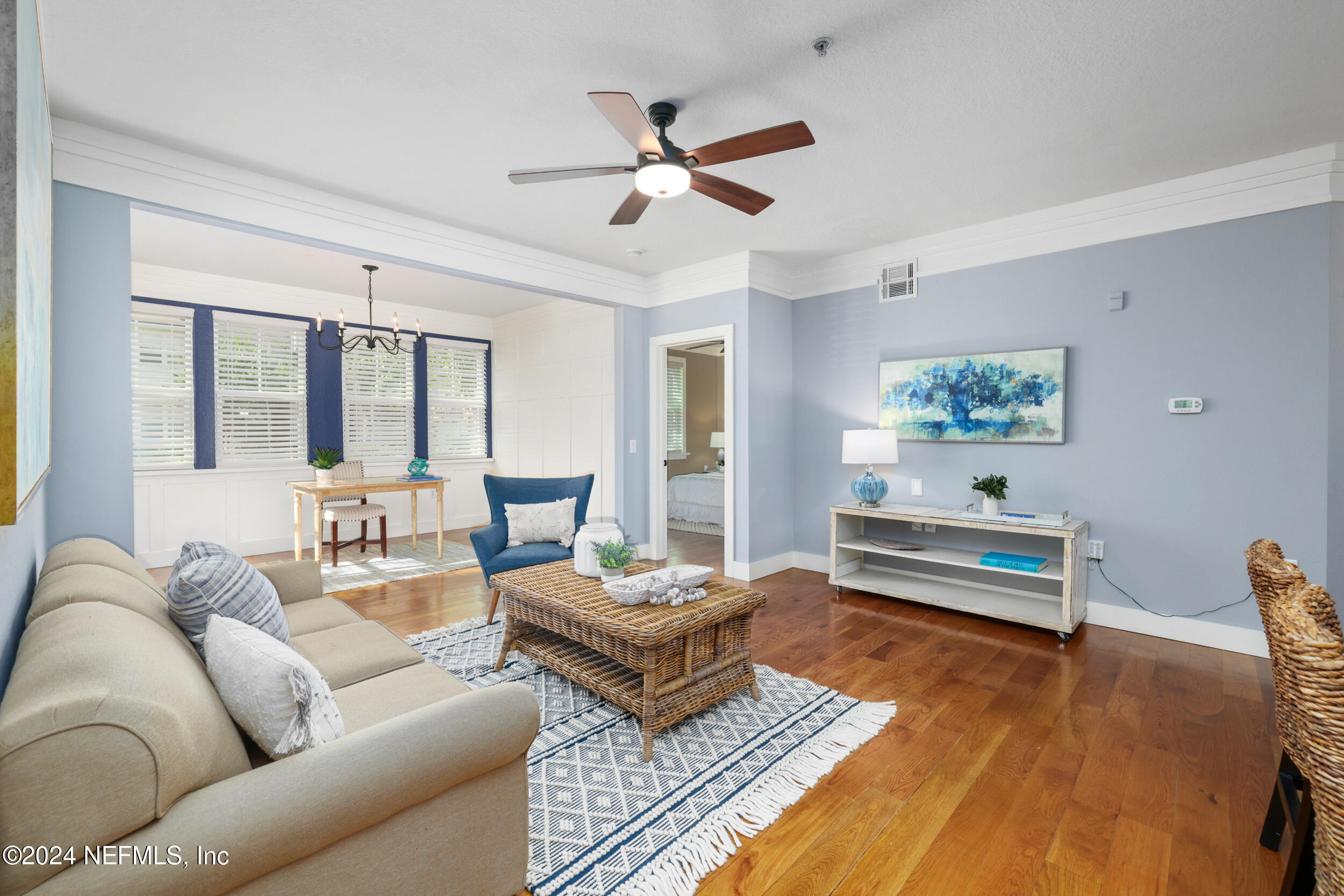 a living room with furniture and wooden floor