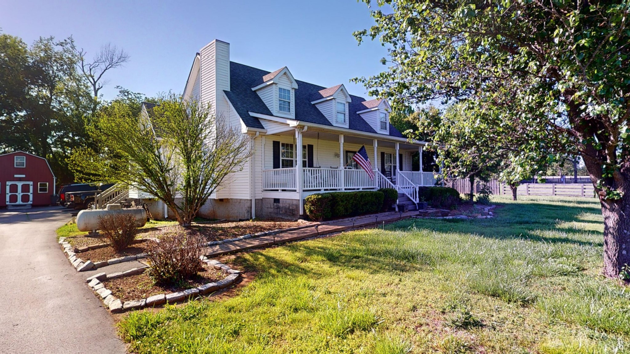 a front view of house with yard and trees around