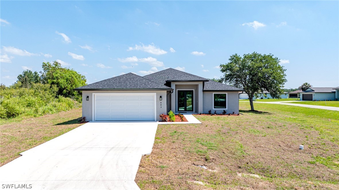 a front view of a house with a yard and garage