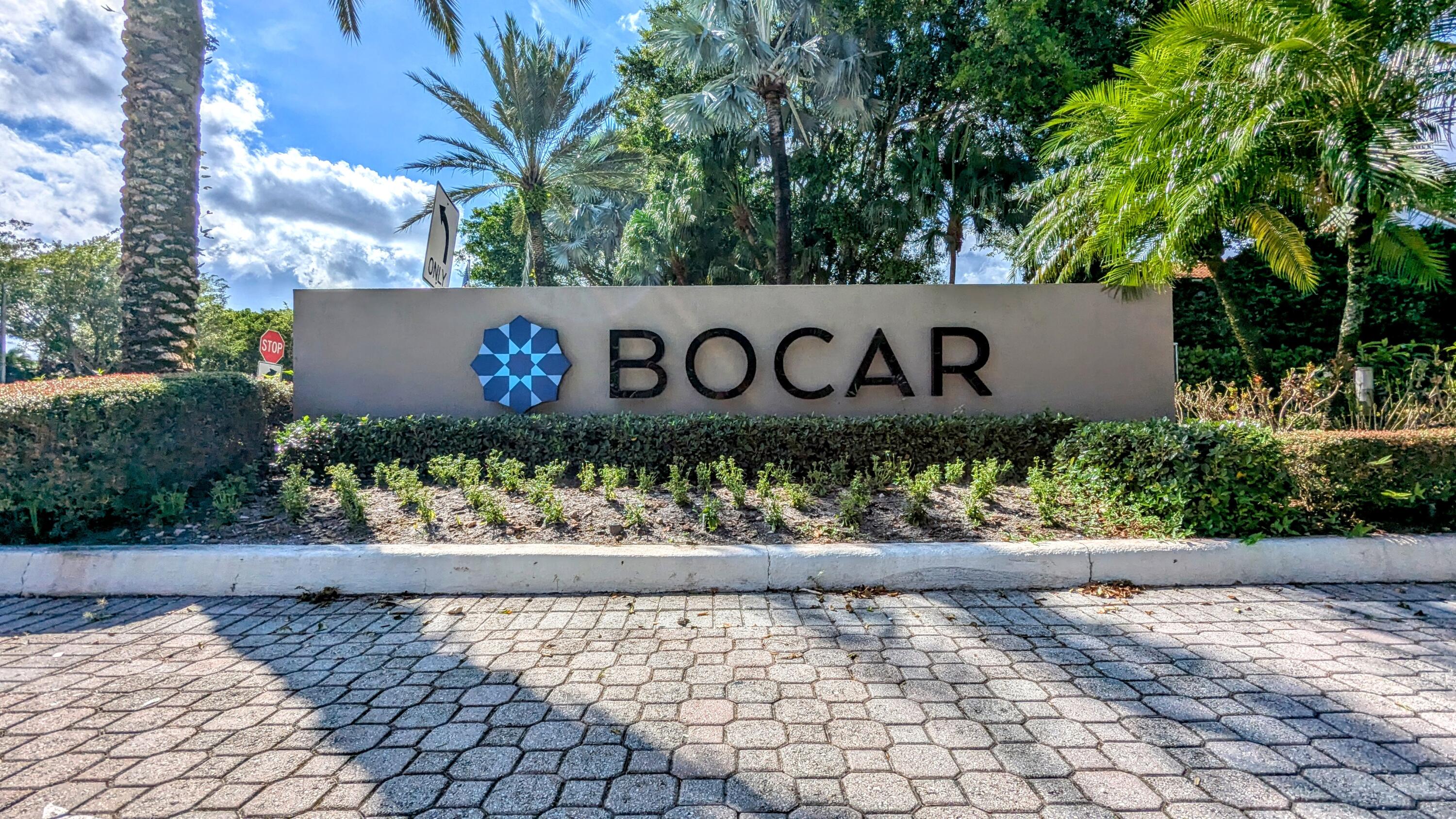 a wooden sign with tree in the background