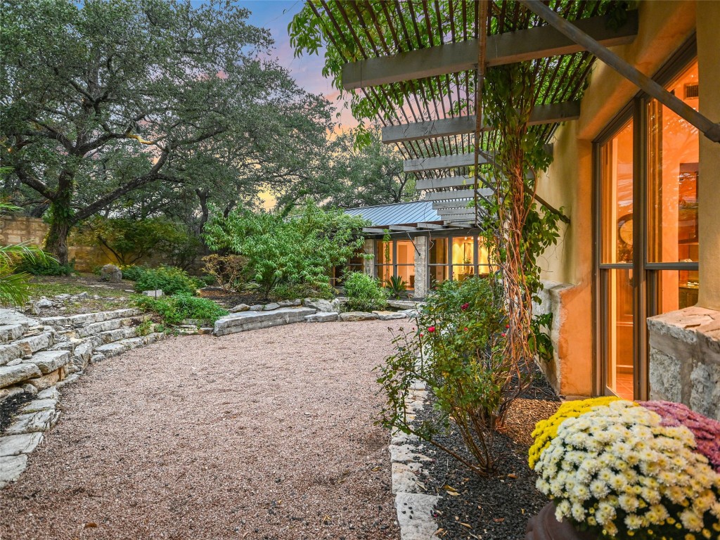 a view of backyard with plants and outdoor seating