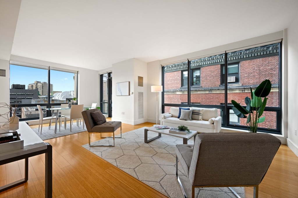 a living room with furniture and a floor to ceiling window