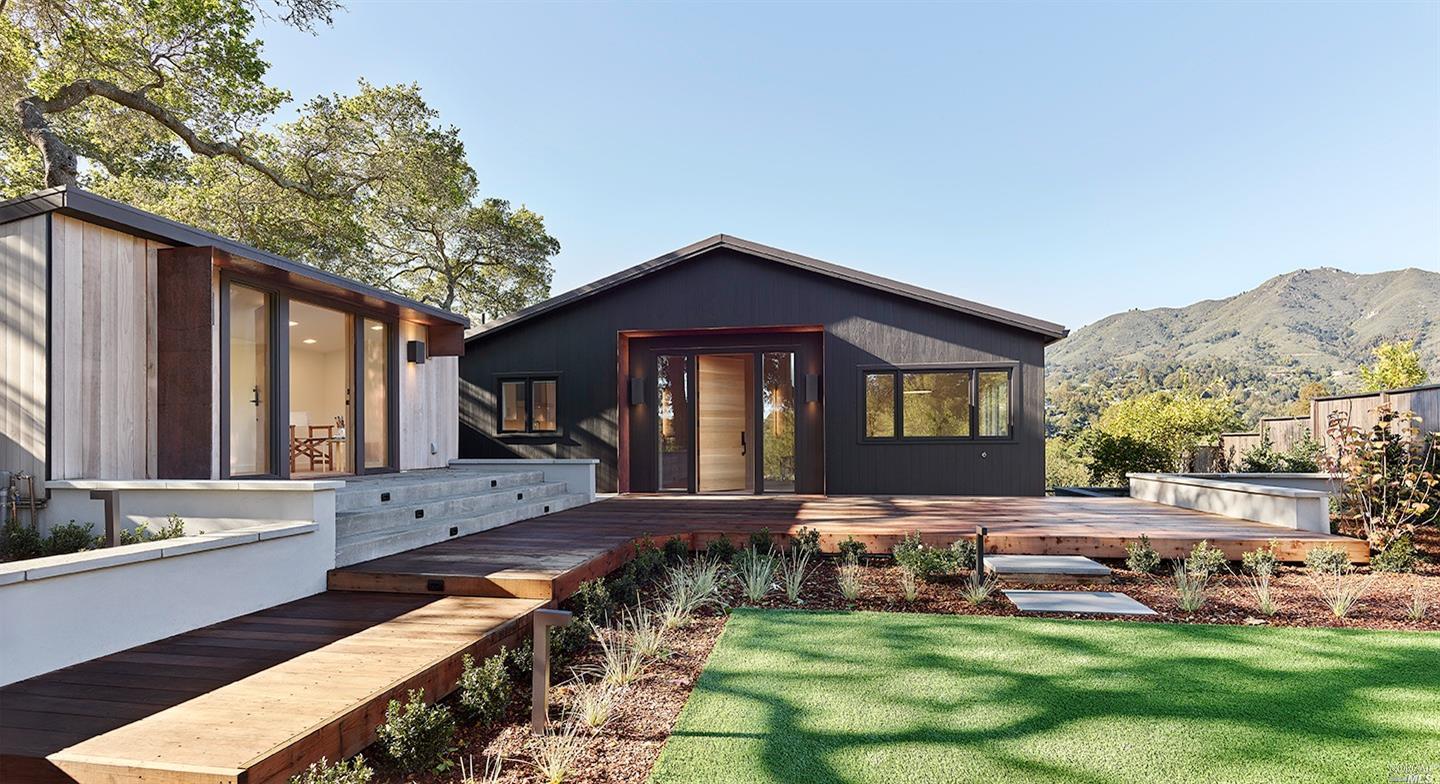 a view of a house with backyard and sitting area