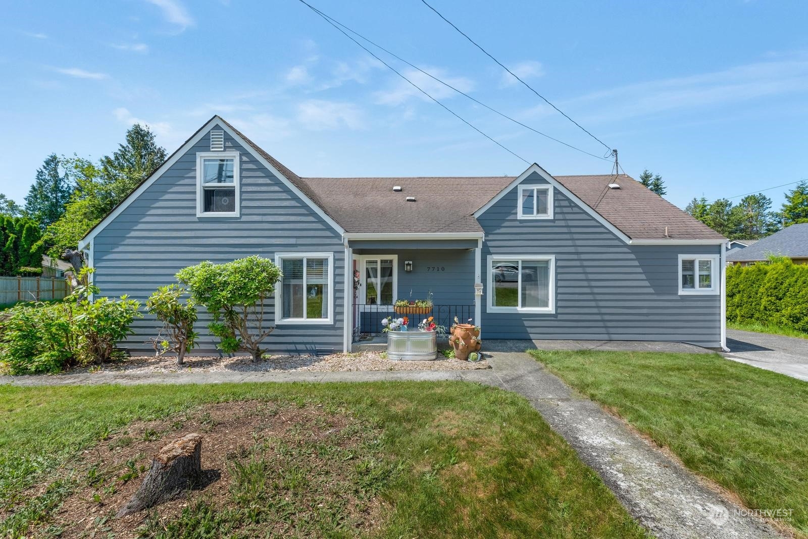 a front view of house with yard and outdoor seating