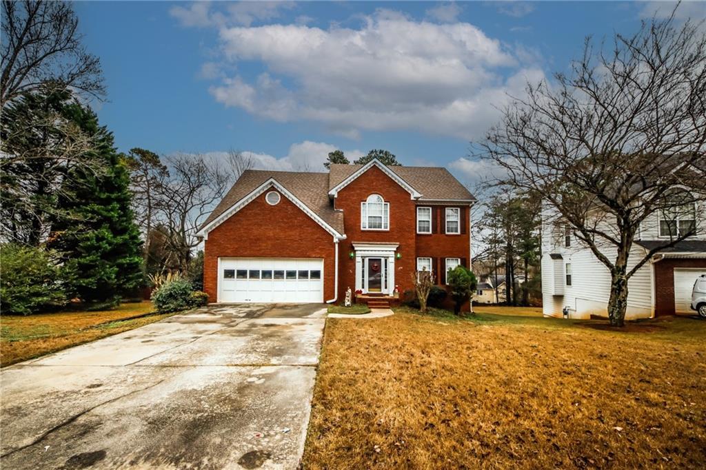 a front view of a house with a yard