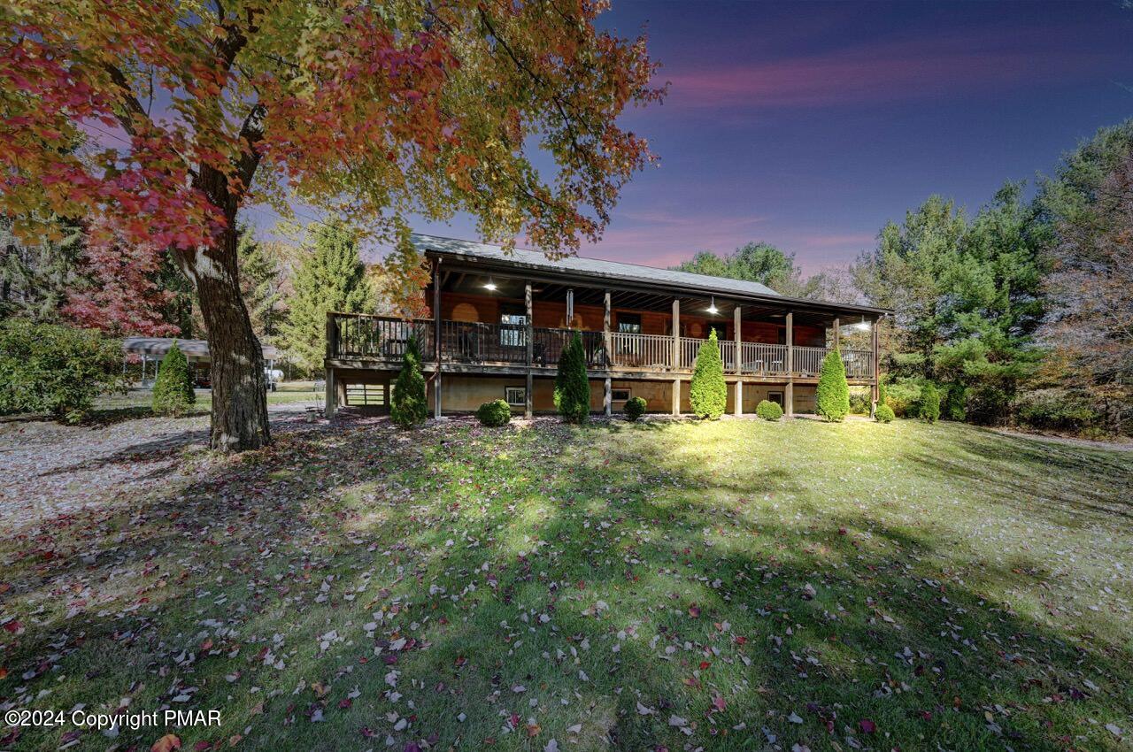 a view of a house with backyard porch and sitting area