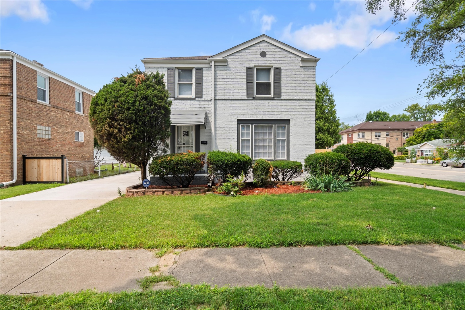 a view of house with yard and green space