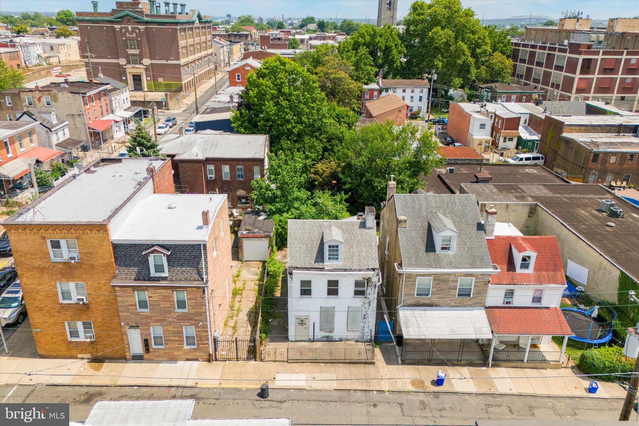 an aerial view of residential houses with outdoor space and parking