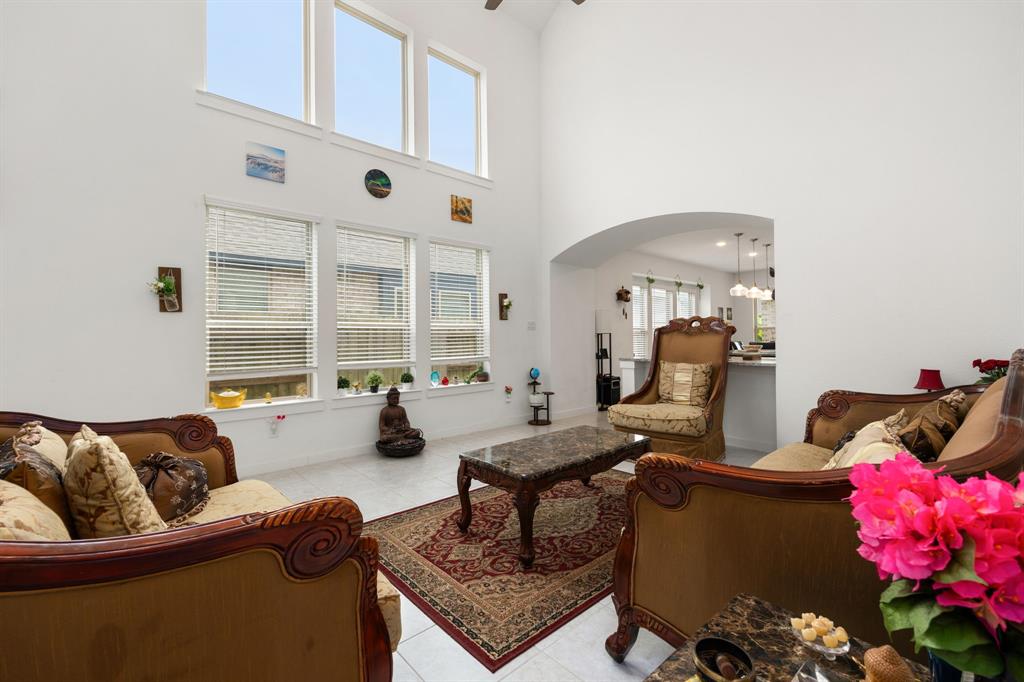 a living room with furniture fireplace and a large window