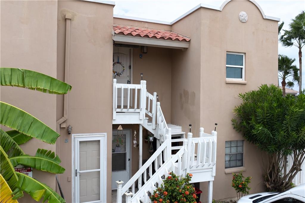 a front view of a house with plants