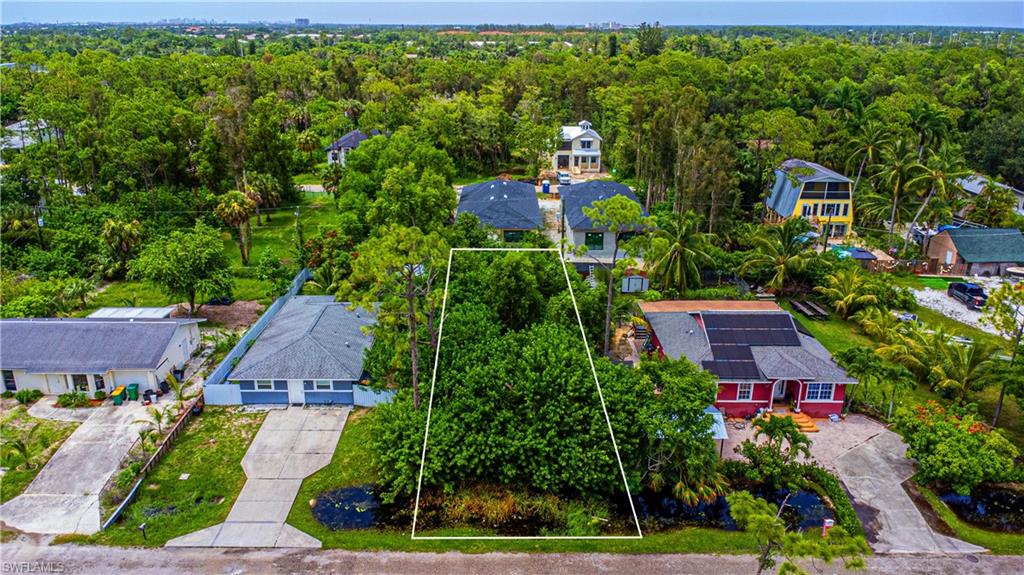 a aerial view of a house with a yard and potted plants