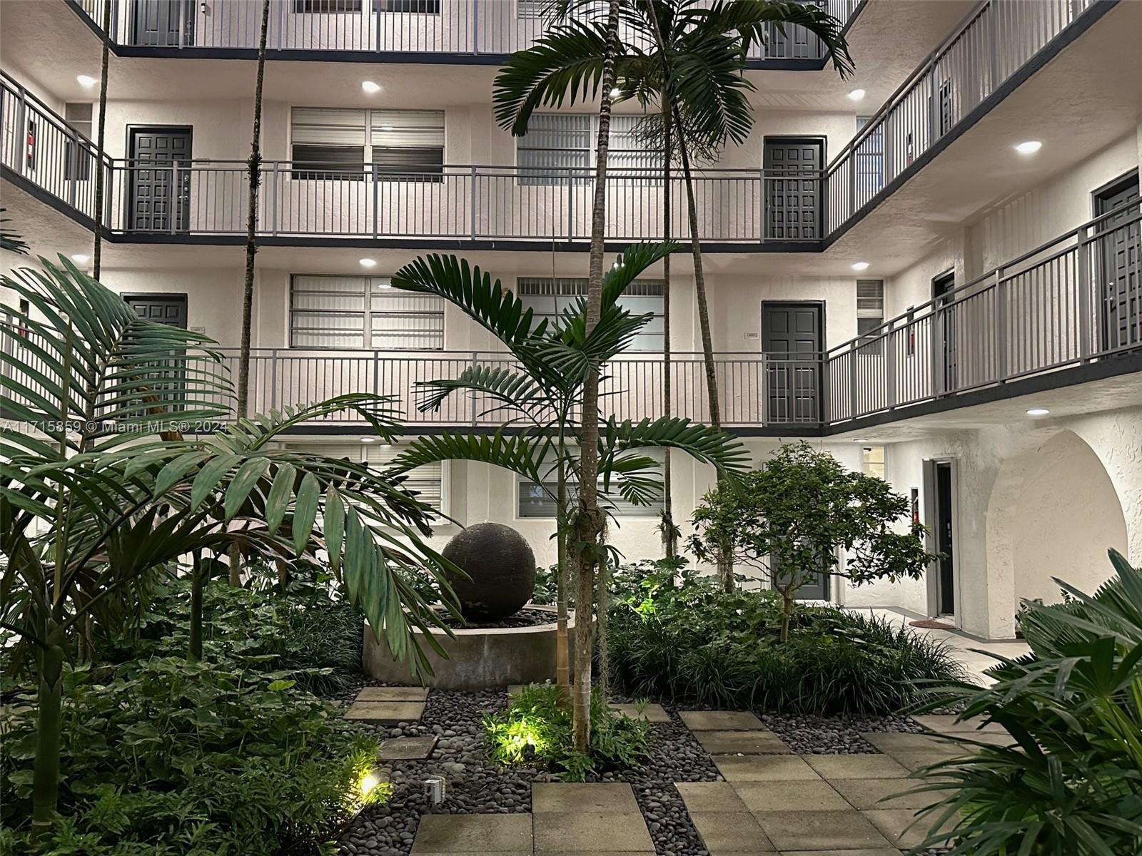 a view of building along with potted plants and a fountain