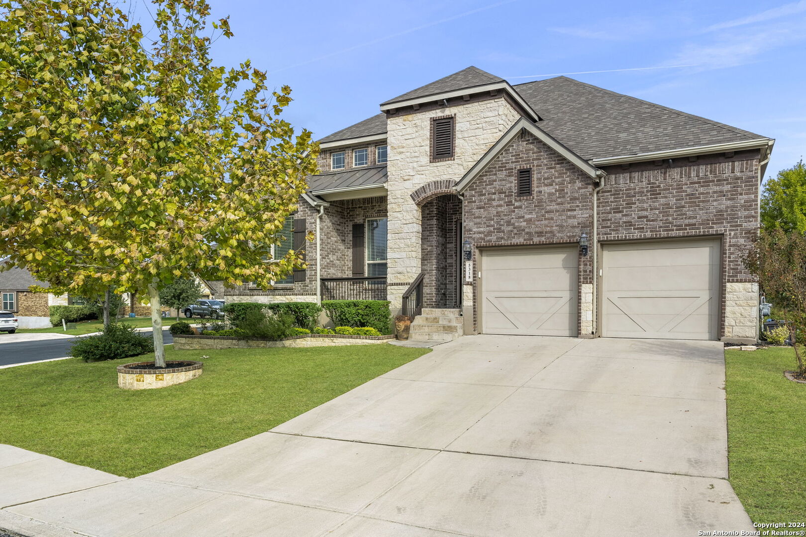 a front view of house with yard and green space