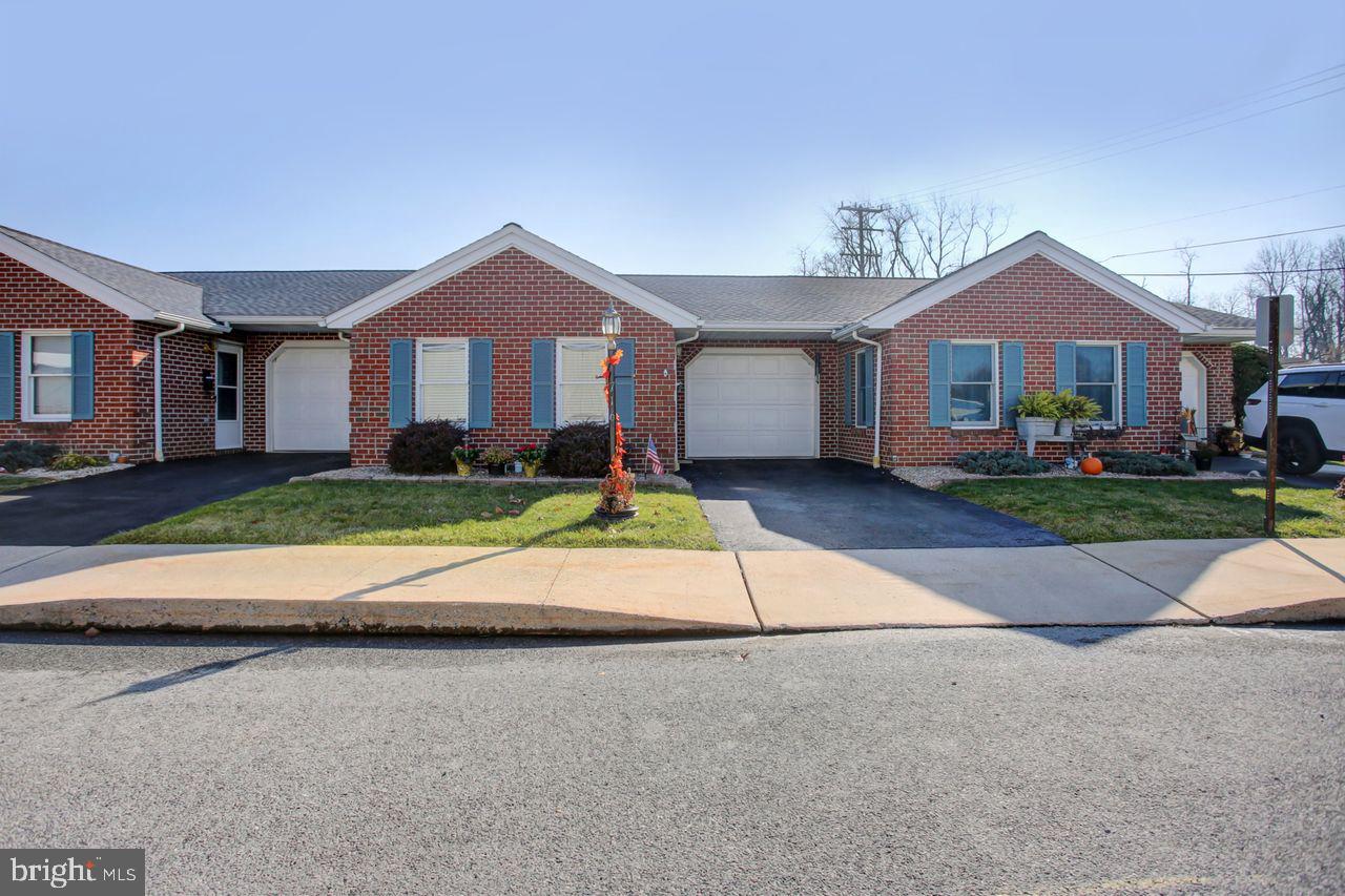 a view of house with yard in front of it