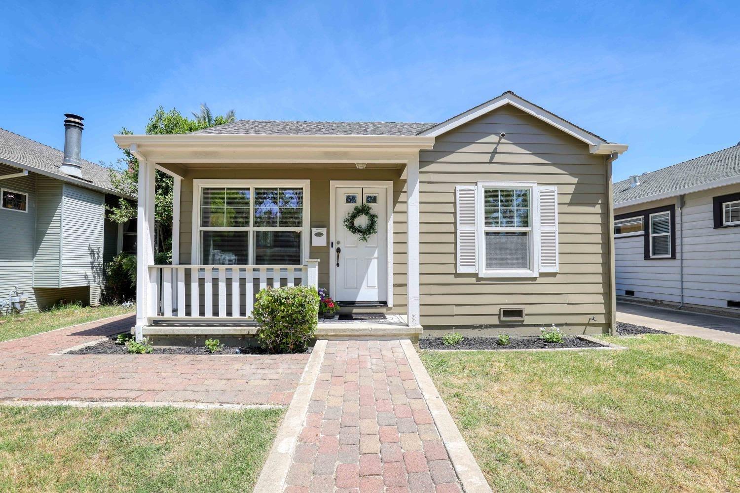 a front view of a house with a garden