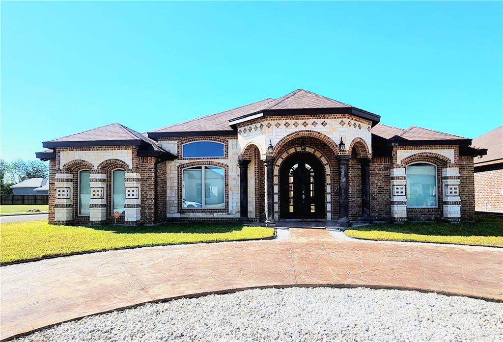 a view of a house with yard and swimming pool