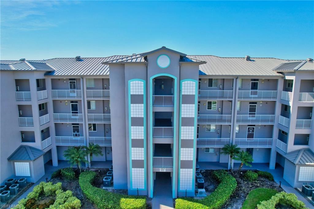 a front view of a building with balcony and outdoor seating