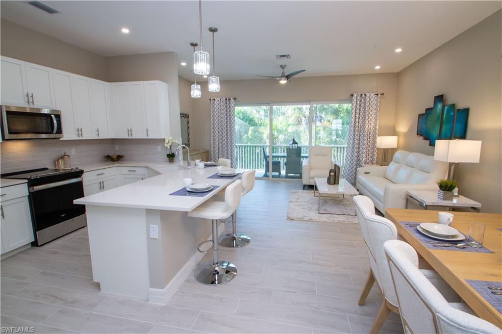 a kitchen with a sink a counter top space appliances and cabinets