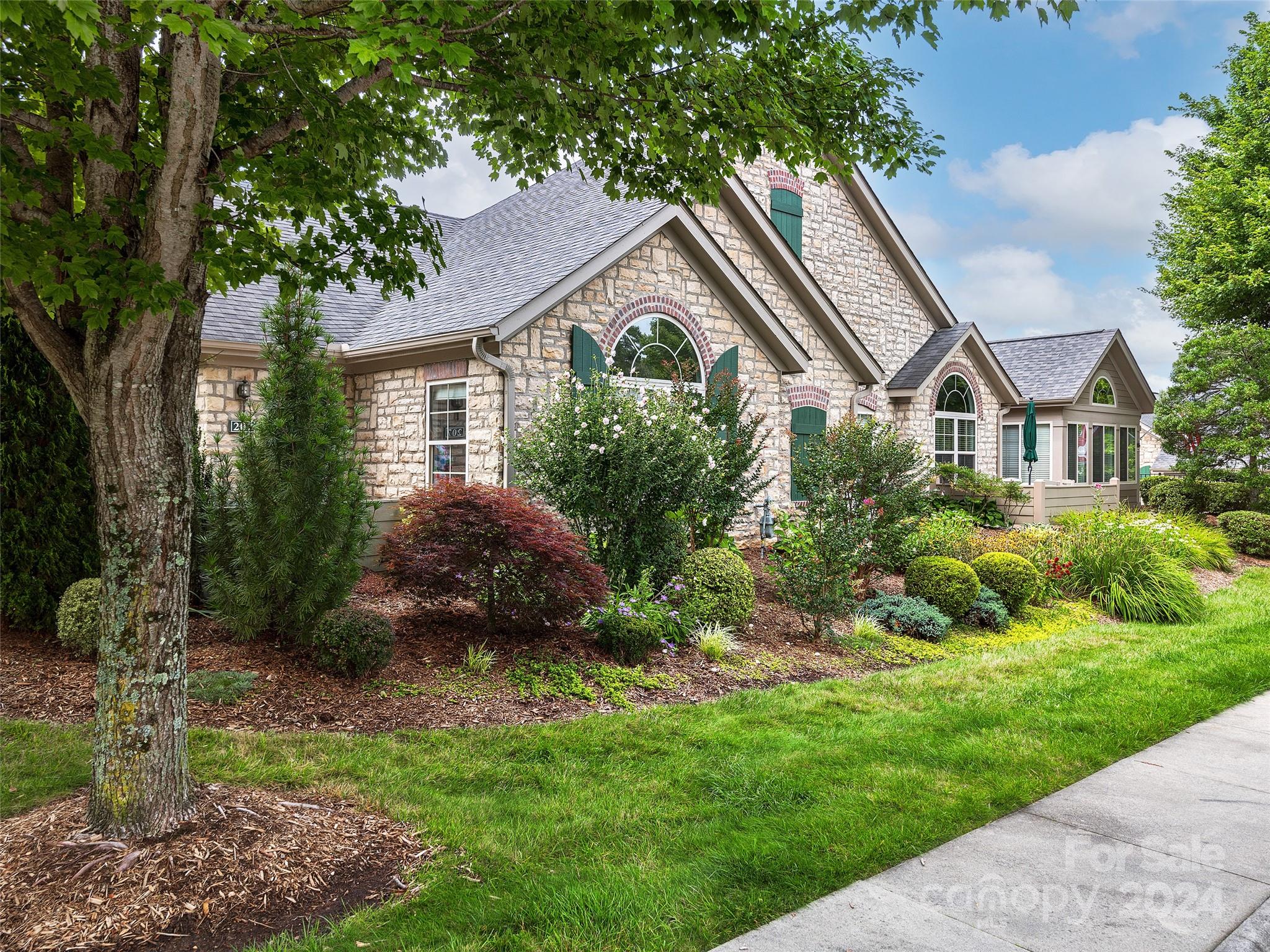 a front view of a house with a garden