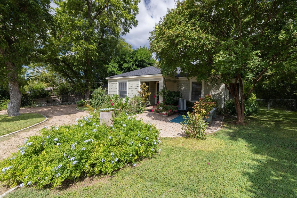 a view of backyard of house with outdoor seating and green space