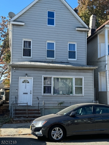 a front view of a house with parking space