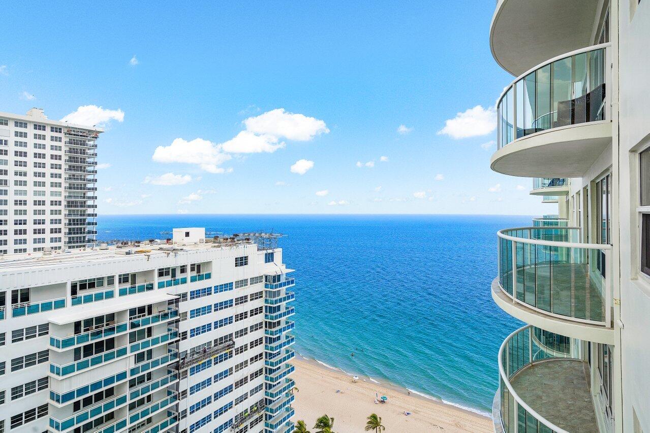 a view of buildings with ocean view