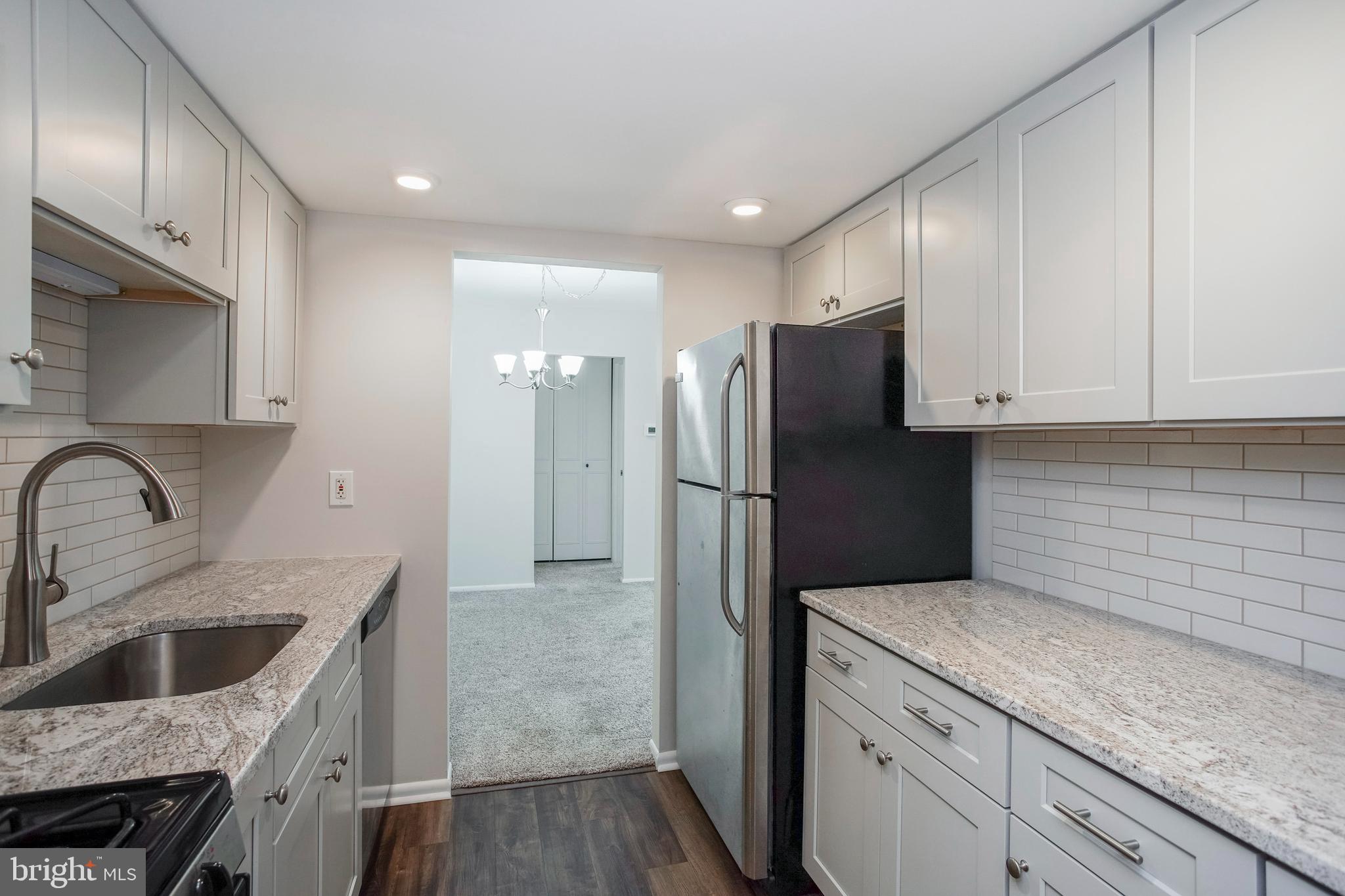 a kitchen with a sink stainless steel appliances and cabinets