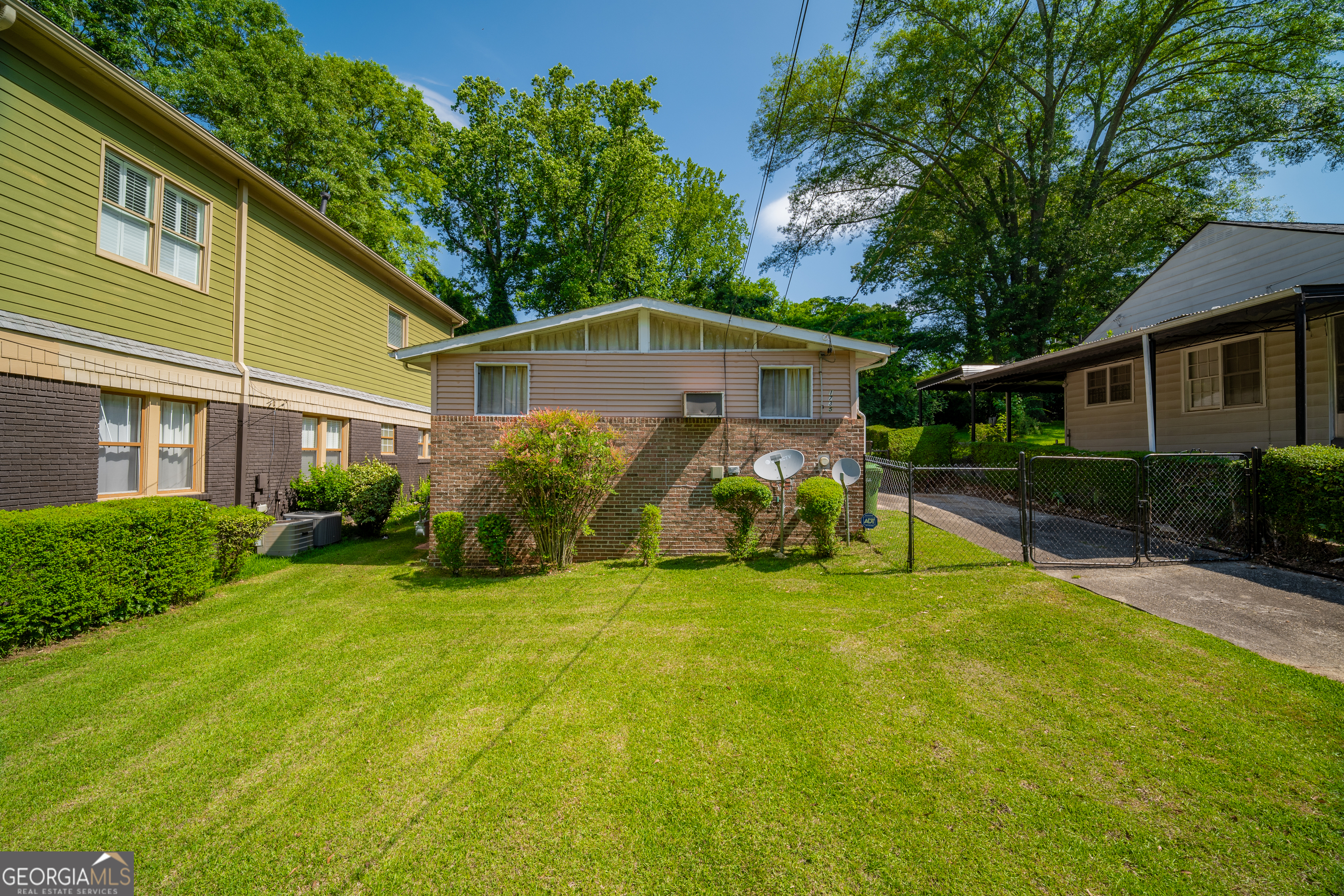 a view of a house with backyard and sitting area