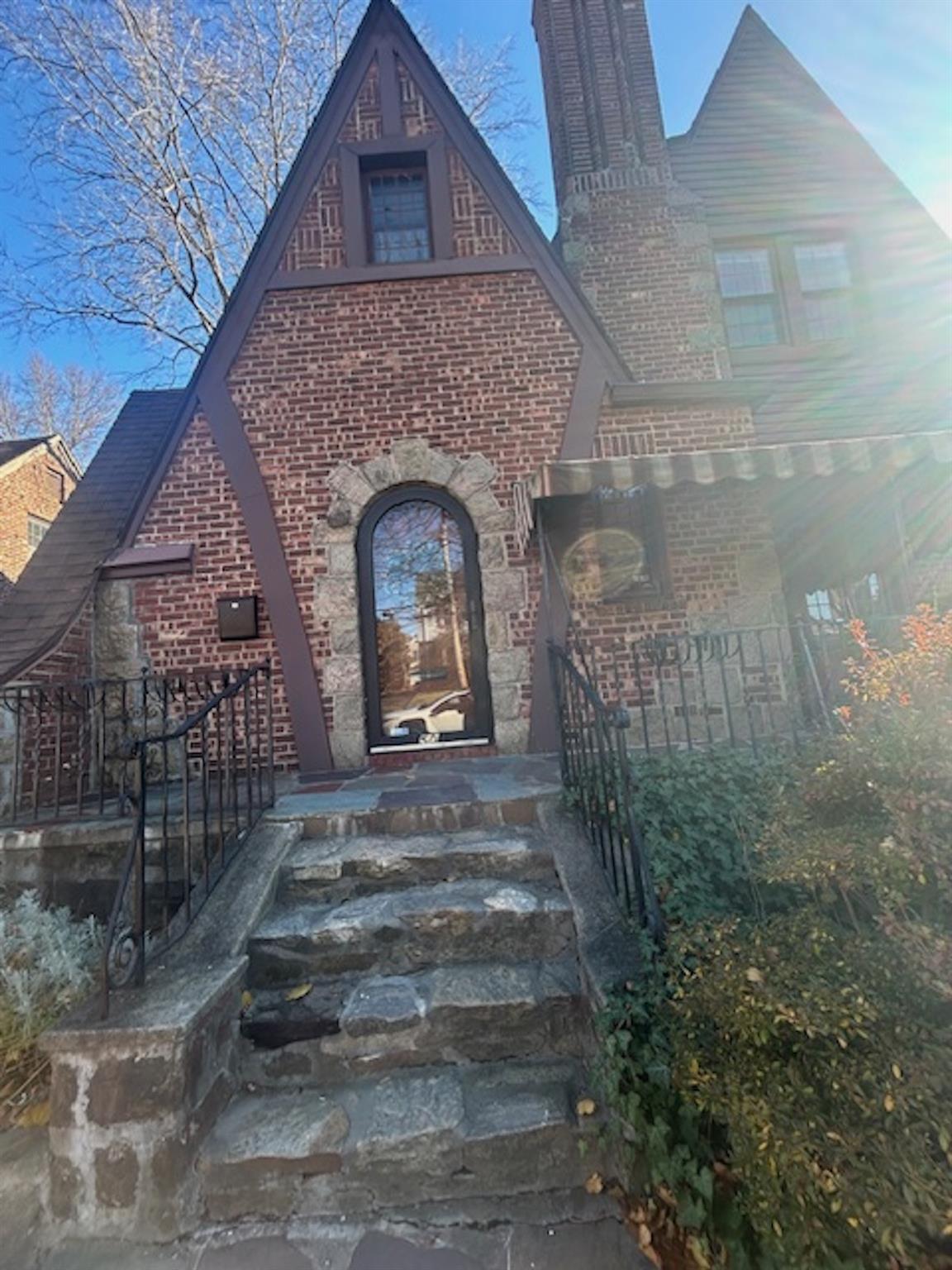 a front view of a house with a garden