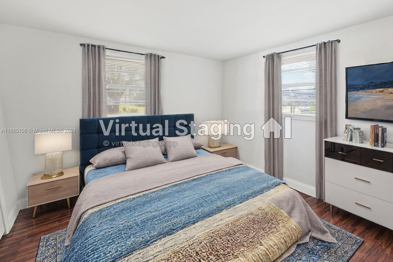 a bedroom with a bed and a flat tv screen on a dresser