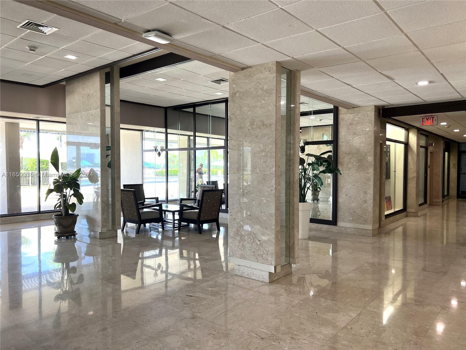 a view of a lobby with furniture and floor to ceiling window