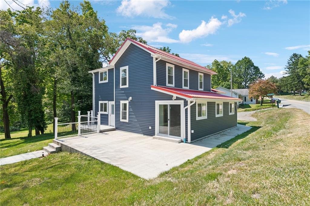 a view of house with yard and entertaining space