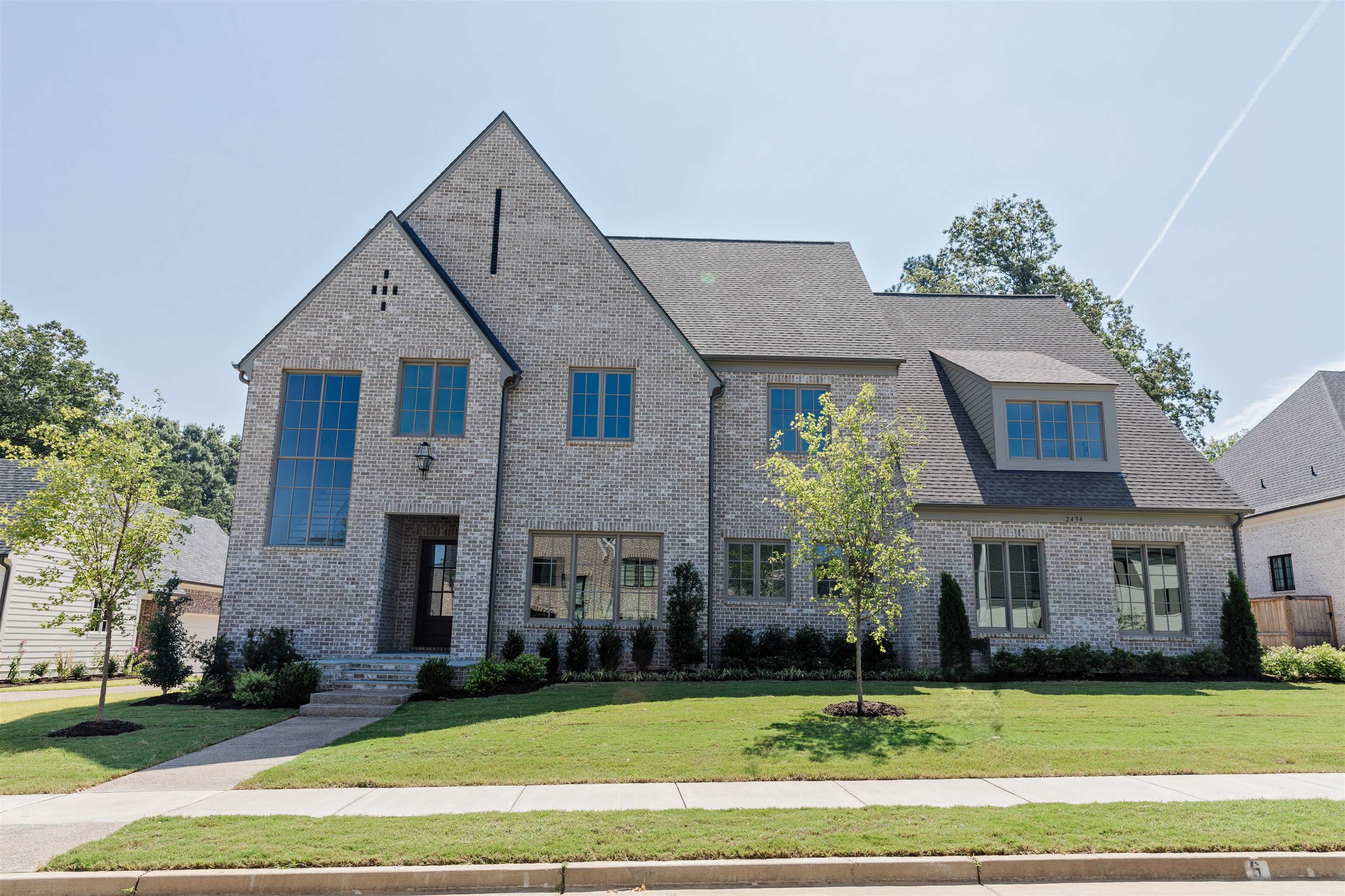 a front view of a house with a garden