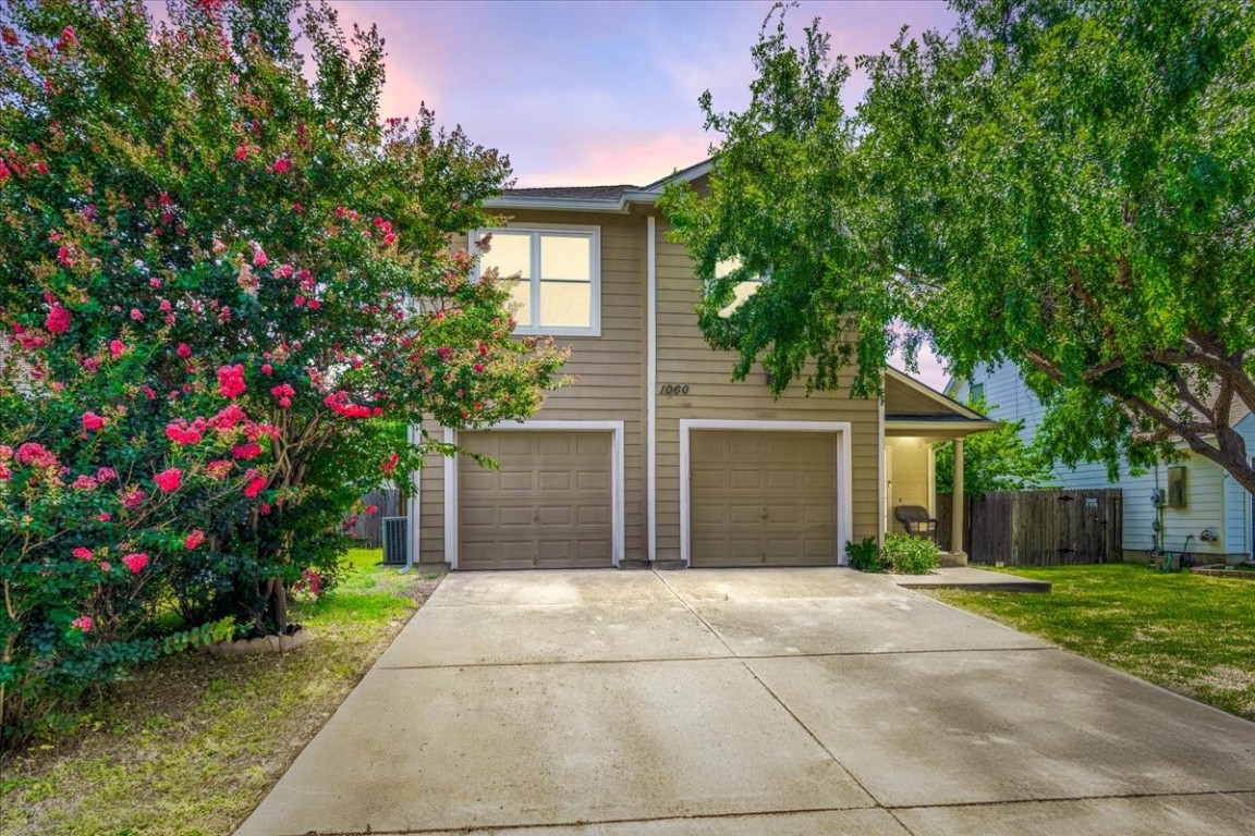 a front view of a house with a yard and a garage