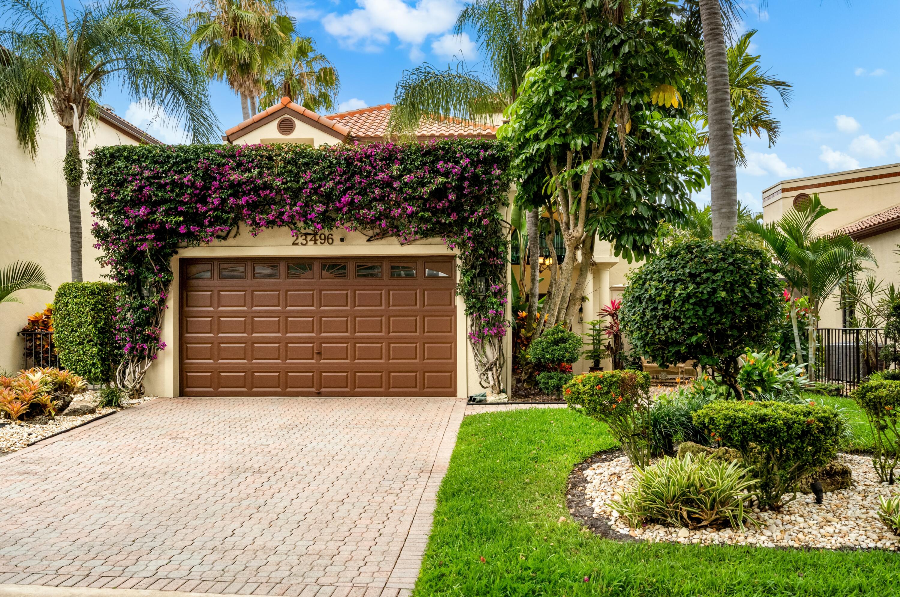 a view of a house with a yard and garage